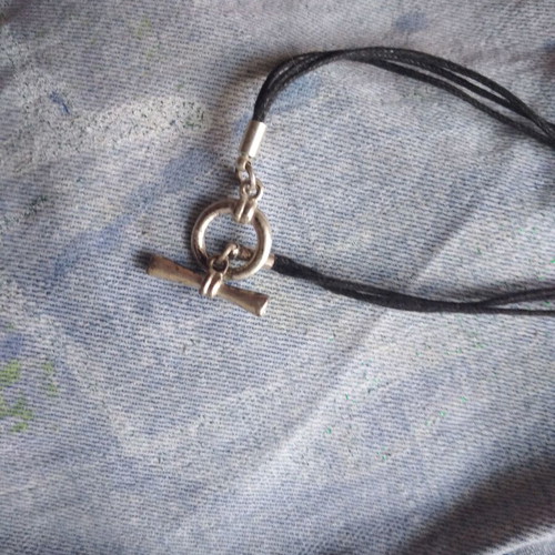 Necklace with steel pendant like new on leather straps