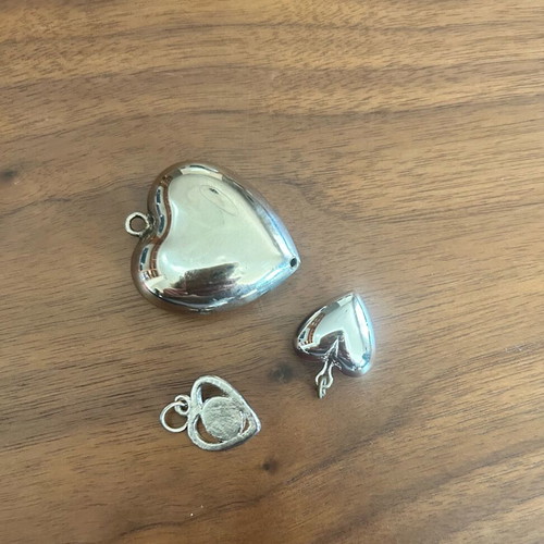 3 heart-shaped pendants like new, silver color