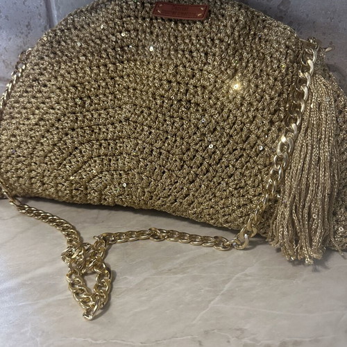 Handmade knitted shoulder bag in gold with decorative tassel