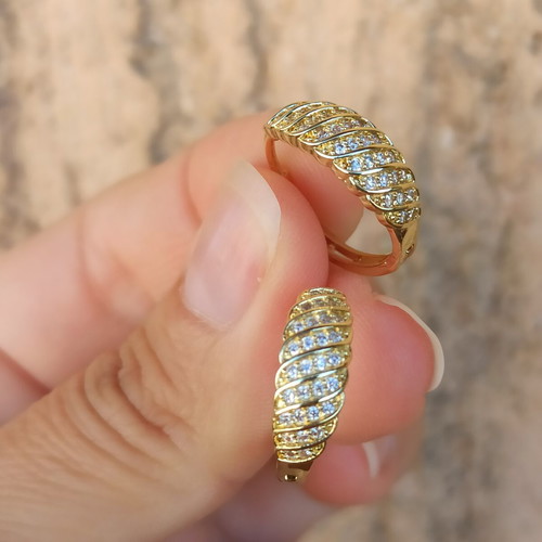 Gold-colored hoop earrings with white zircon stones, copper