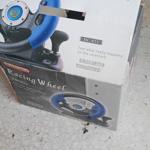 Steering wheel for PlayStation 2 used with signs of wear