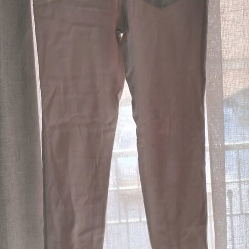 White fitted leggings-style pants with rips and rhinestones used, size S