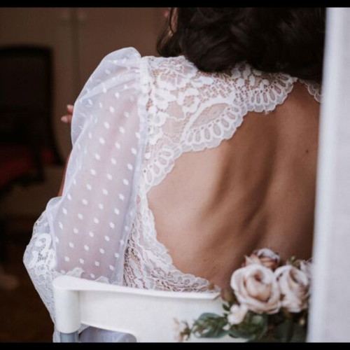 Romantic vintage-inspired wedding dress with polka dot tulle and lace
