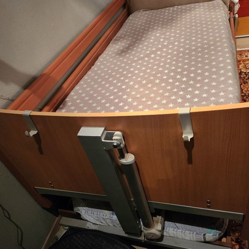 Electric hospital bed used with headboard