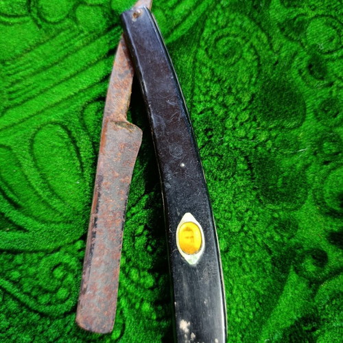 Vintage straight razors with leather strop and wooden handle