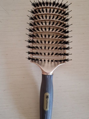Hair comb with short bristles and openings