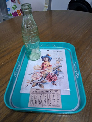 Coca-Cola advertising tray and glass bottle used