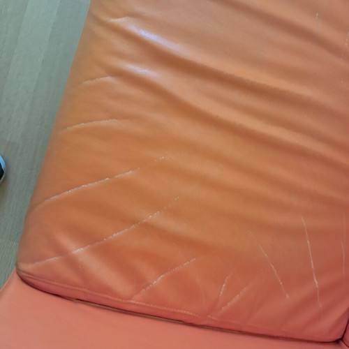 Orange two-seater sofa leather used with minor damages