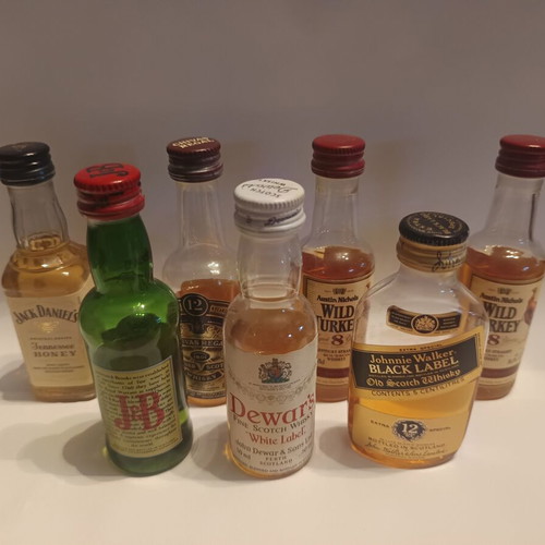 7 mini whiskey bottles, sealed plastic