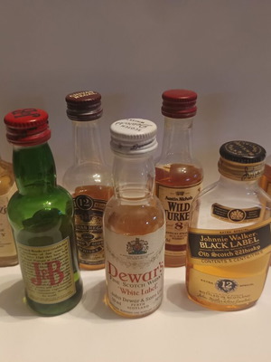 7 mini whiskey bottles, sealed plastic
