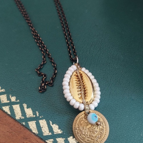 Long necklace with shell and evil eye pendant