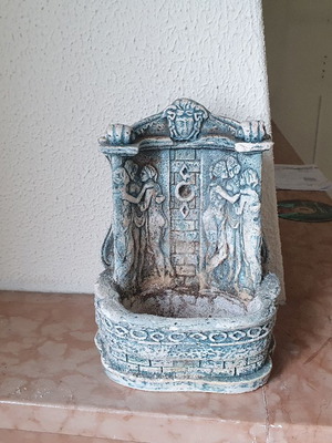 Decorative fountain spout used with embossed figures
