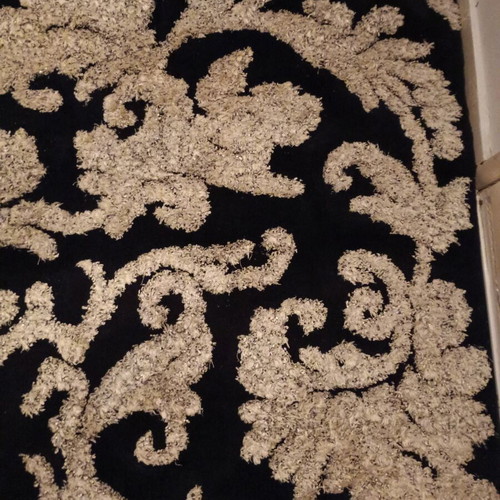Black and white rug with embossed designs 226x152 cm