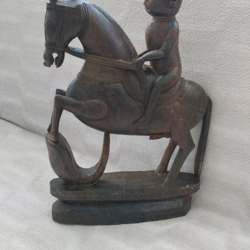 Wooden carving of South Indian man riding horse used