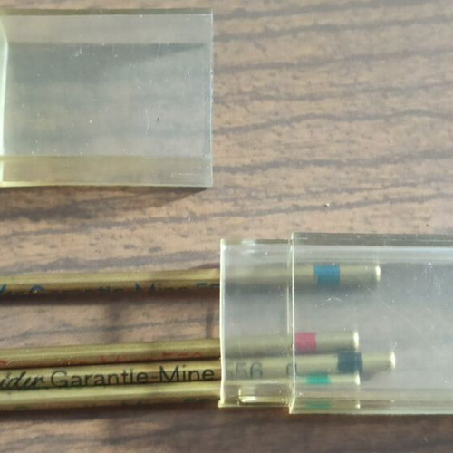 Wooden stationery box with used pencils and ink cartridges set