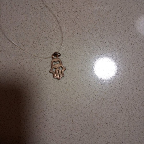 Hamsa pendant with transparent synthetic fishing line used