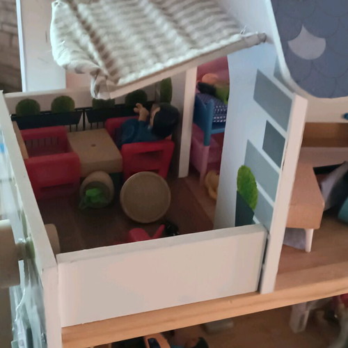 Wooden dollhouse used with extra accessories pack