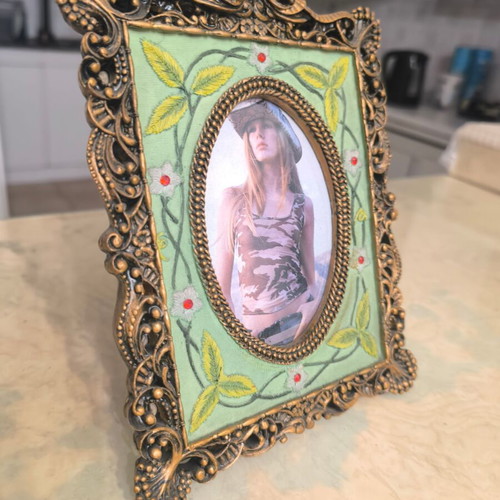 Vintage photo frame with oval opening and embossed design like new