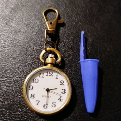 Quartz keychain watch like new, brass color, white dial