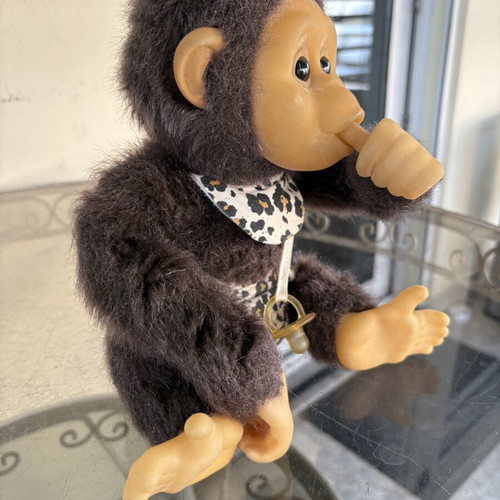 Vintage plush monkey toy with sound and hanging feature