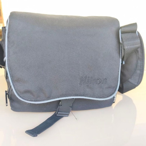 Nikon D3000 camera with AF-S 18-55mm f/3.5-5.6 lens and bag