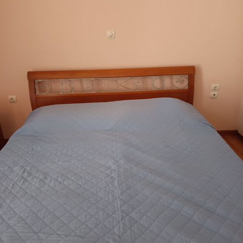 Double bed with decorated beech wood headboard