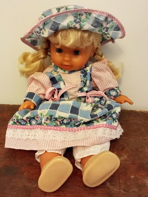 Collectible vintage doll with blonde hair and traditional dress, like new