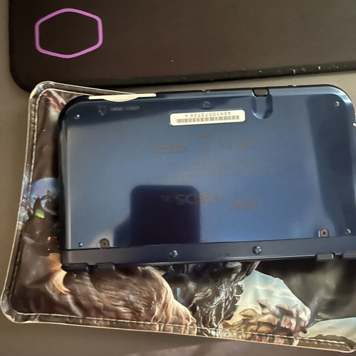 Nintendo 3DS New XL console with charger and Monster Hunters case