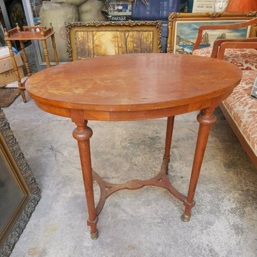 Vintage oval wooden coffee table used with brass feet