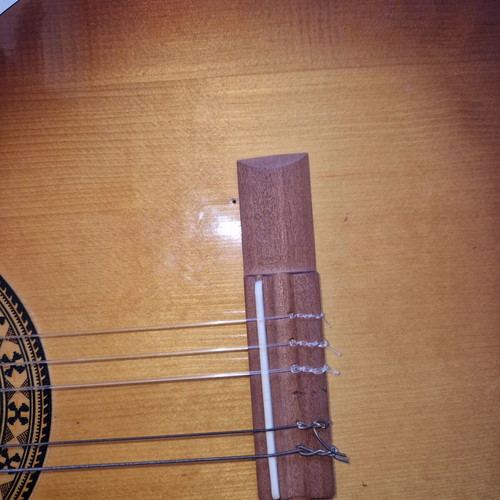 Classical guitar used with case, missing one string and small hole