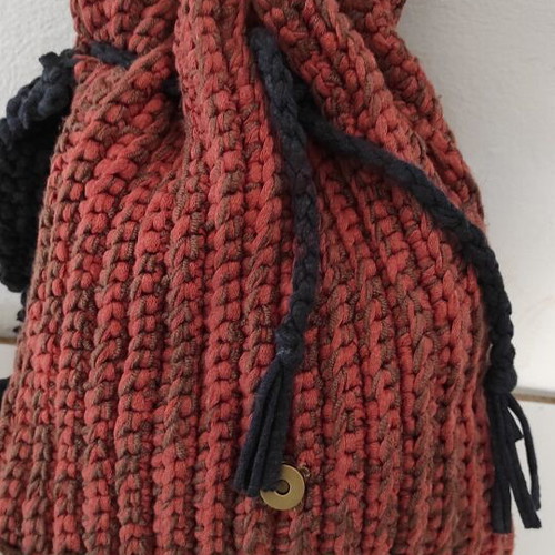 Knitted backpack like new, orange with leather hamsa detail