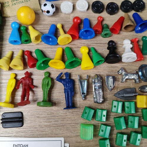 Lot of used board game parts including pawns, dice, cards, and hourglasses