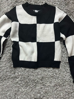 Women's knitted sweater used with checkerboard pattern in black and white