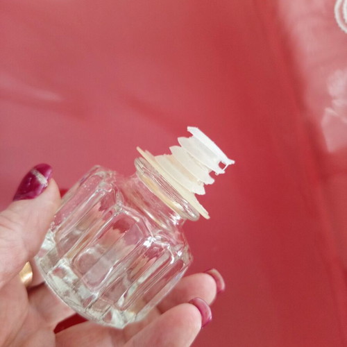 Vintage glass decanter with embossed geometric design and stopper