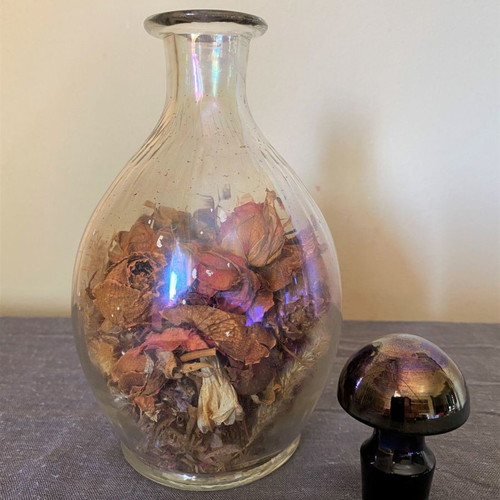 Vintage glass bottle with metal stopper and dried flowers used
