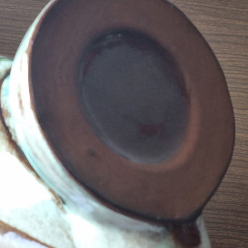 Ceramic owl pitcher used, broken and glued on the beak