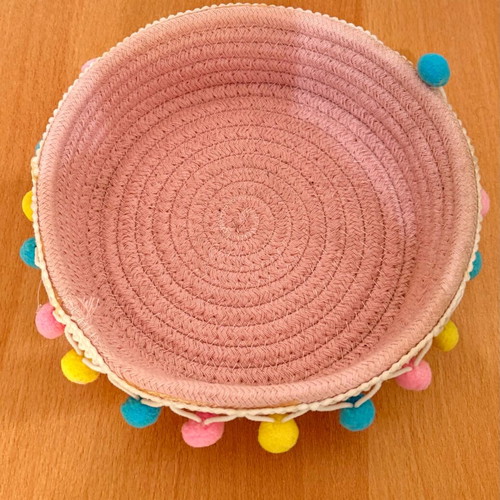 Handmade pink basket with colorful pom poms like new
