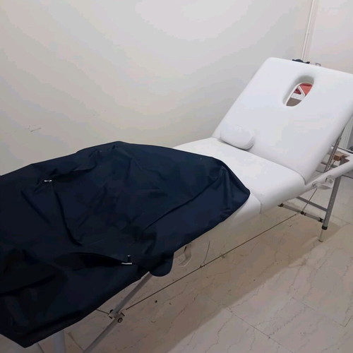 Massage bed like new, white with nickel base and folding feature