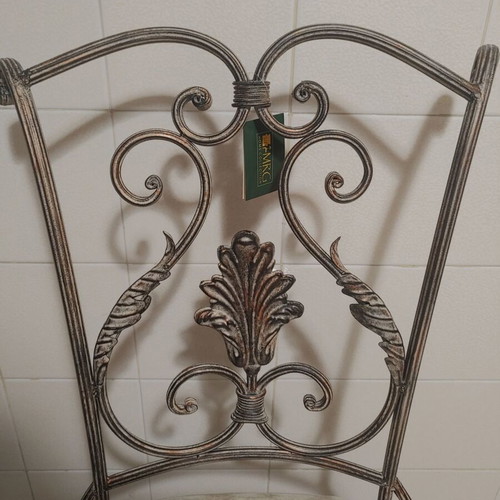 Set of 2 wrought iron dining chairs with decorative leaf details