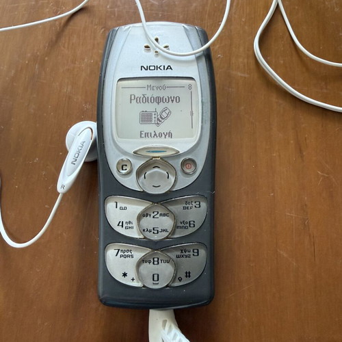 Nokia 2300 mobile phone with charger and headphones