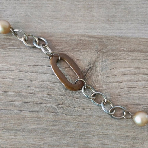 Long necklace chain with decorative elements like new, gold-colored