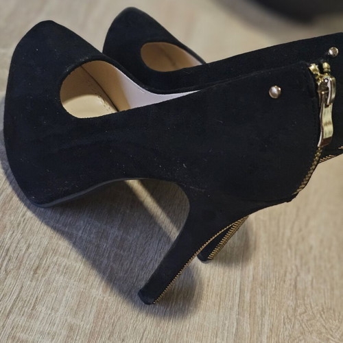 Black suede high heels with gold zipper