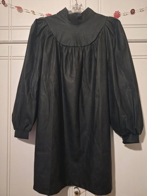Leather dress like new, black with turtleneck collar and puffed sleeves
