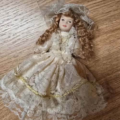 Glass bride doll like new with hat and lace