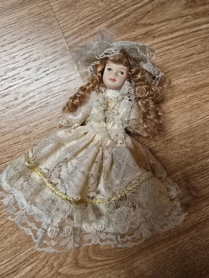 Glass bride doll like new with hat and lace