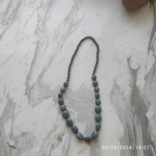 Long necklace with gray celluloid beads used