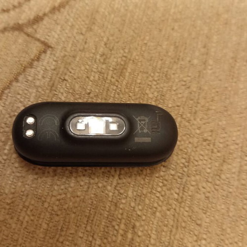 Mi Band smart watch used with charger, strap needs replacement