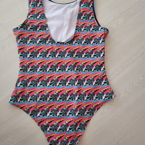 One-piece swimsuit like new, medium, colorful design with padding pocket