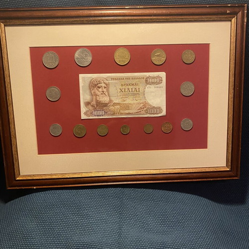 Collection of Greek drachma coins used with thousand drachma note