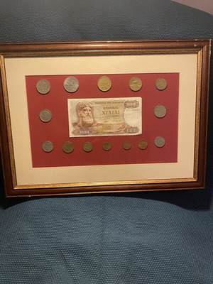 Collection of Greek drachma coins used with thousand drachma note